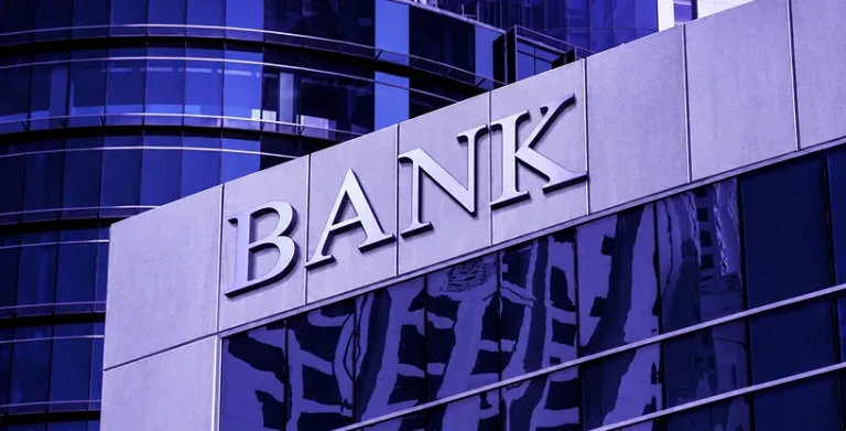 A modern bank building facade with large BANK lettering