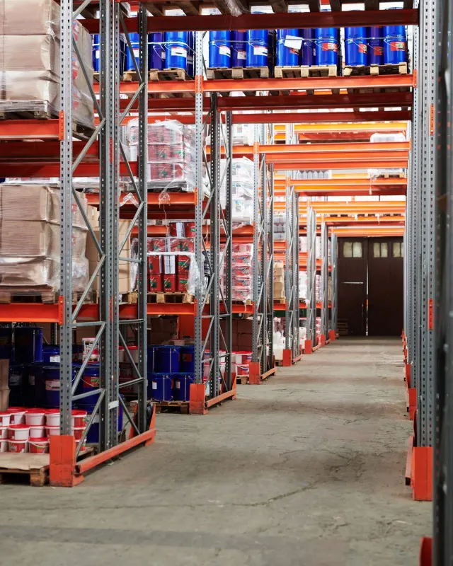 Rows of tall shelving stocked with goods in a warehouse